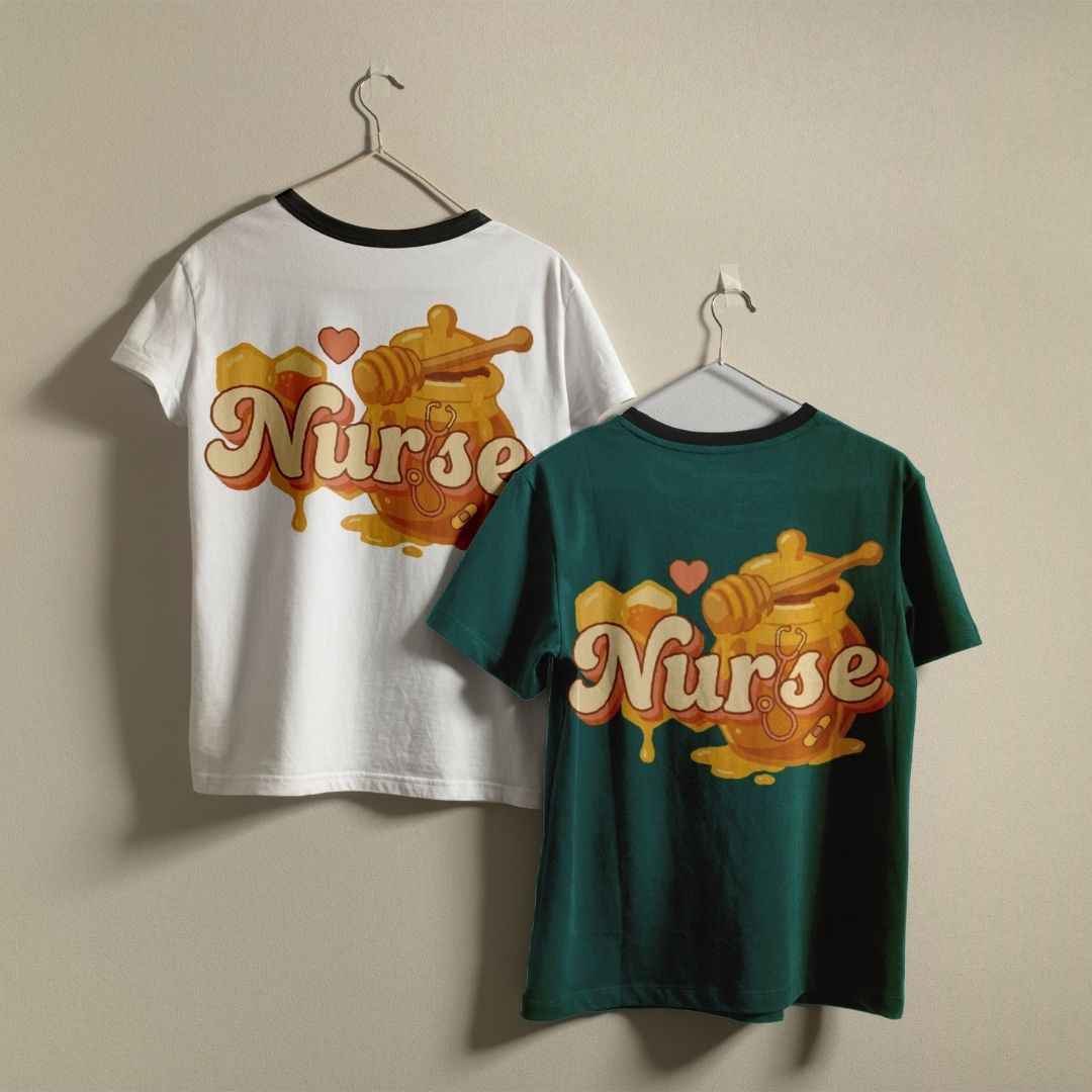 Two t-shirts with 'Nurse' design on hangers against a beige wall.