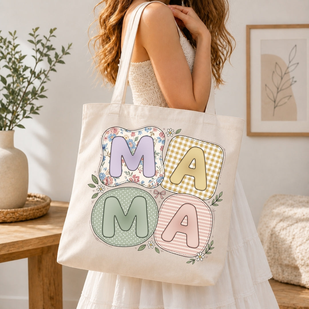 Person in a white dress carrying a canvas tote bag printed with the cute cottagecore "MAMA" design.