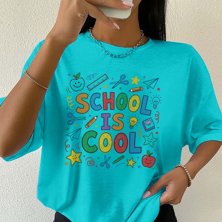 Person wearing a turquoise t-shirt with 'School is Cool' text and graphics.