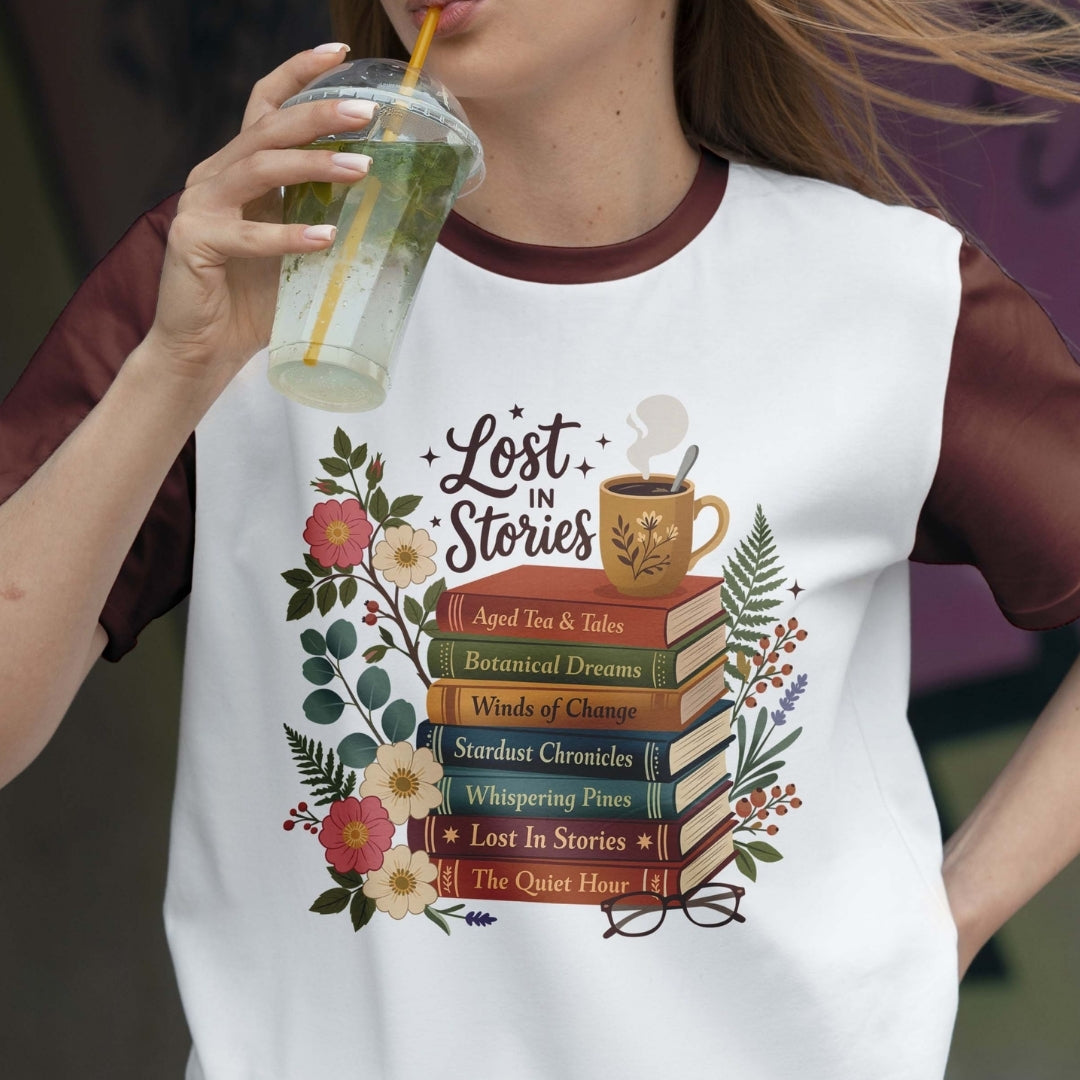 Person wearing a white t-shirt with 'Lost in Stories' design, holding a drink.