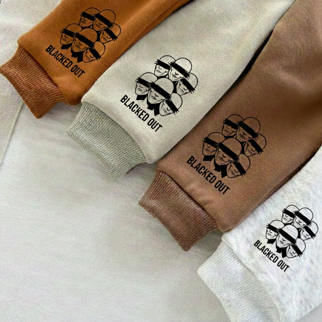 Four sweatpants with 'Blacked Out' design on a light background