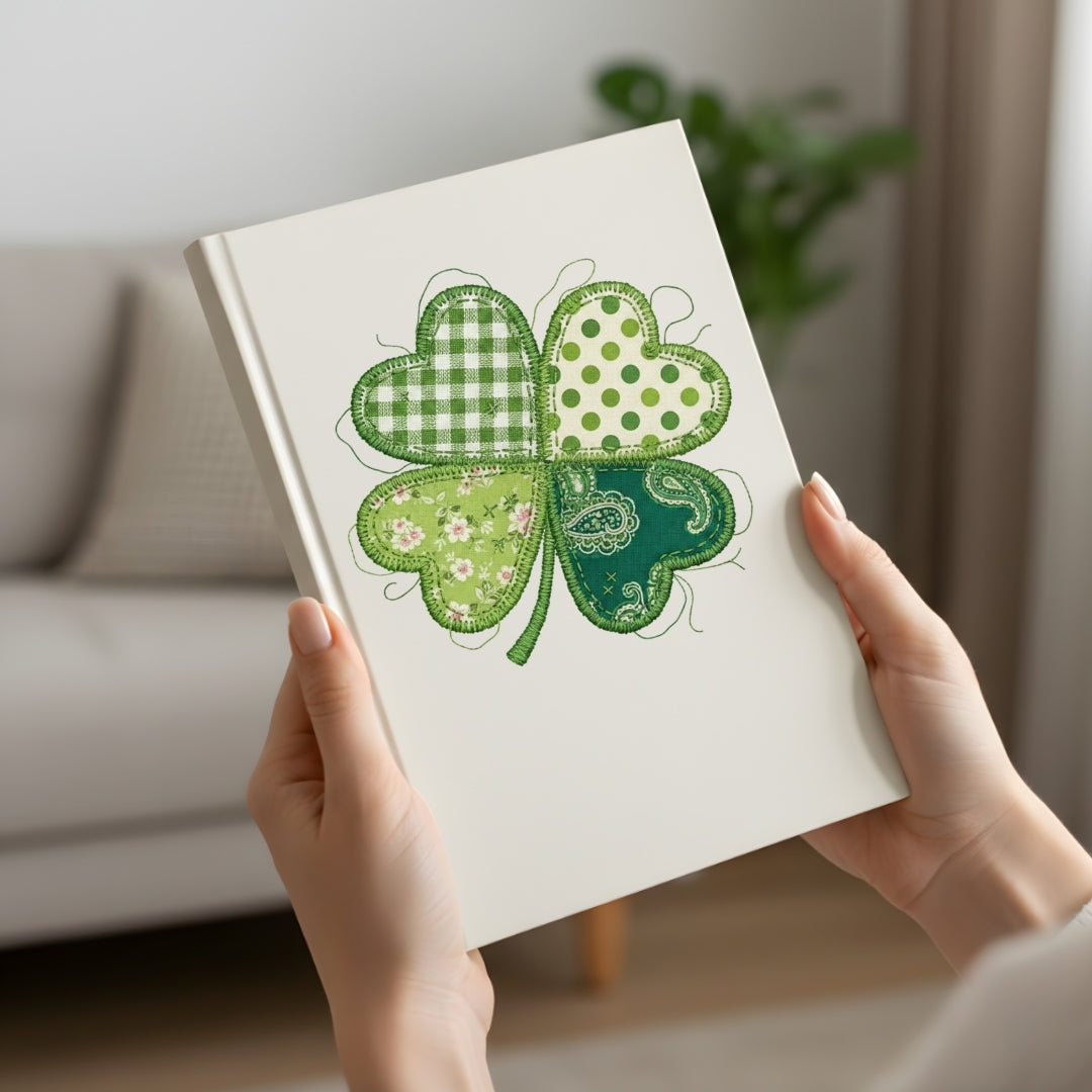 Notebook with a green four-leaf clover design held by hands in a home setting.
