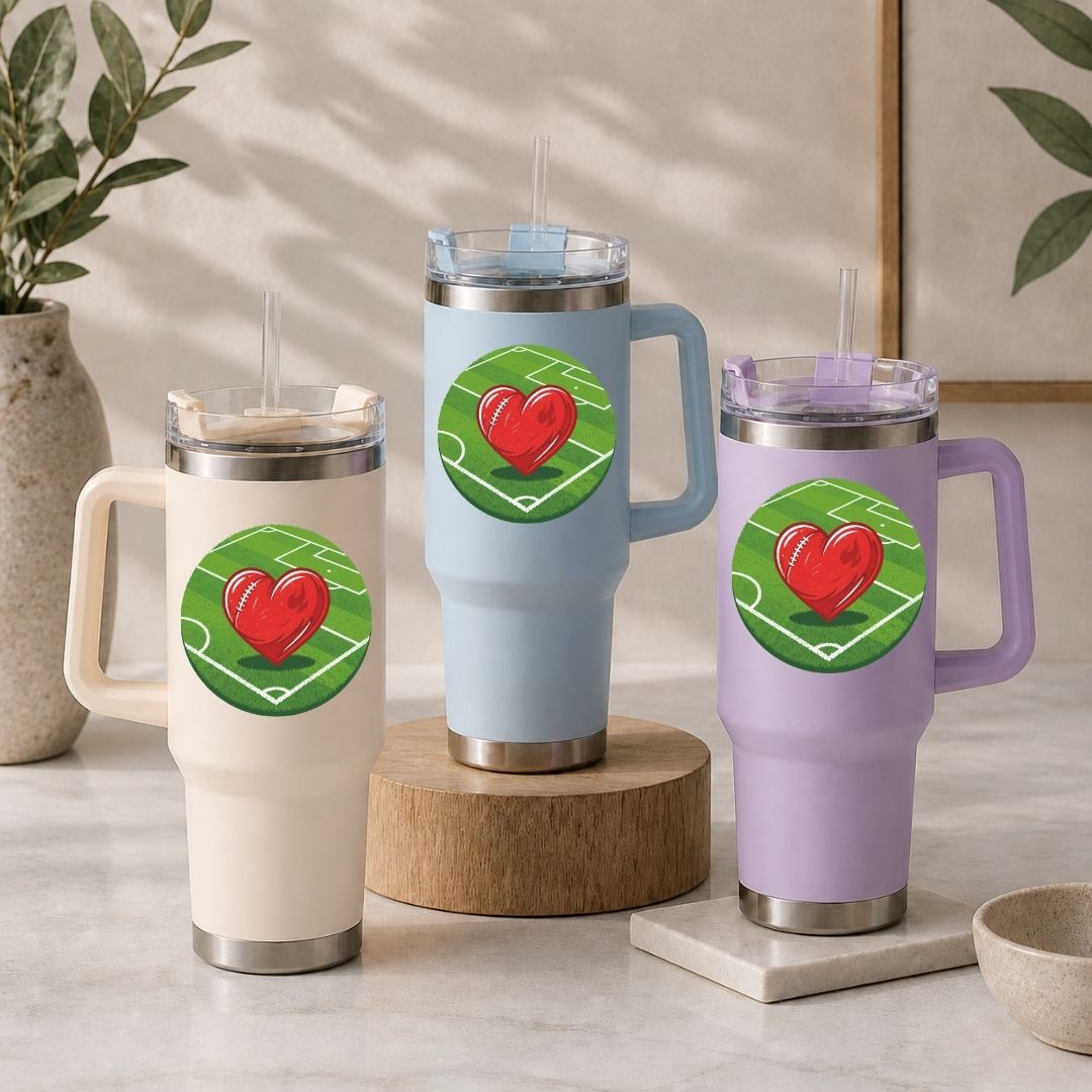 Three insulated travel mugs with heart designs on a neutral background