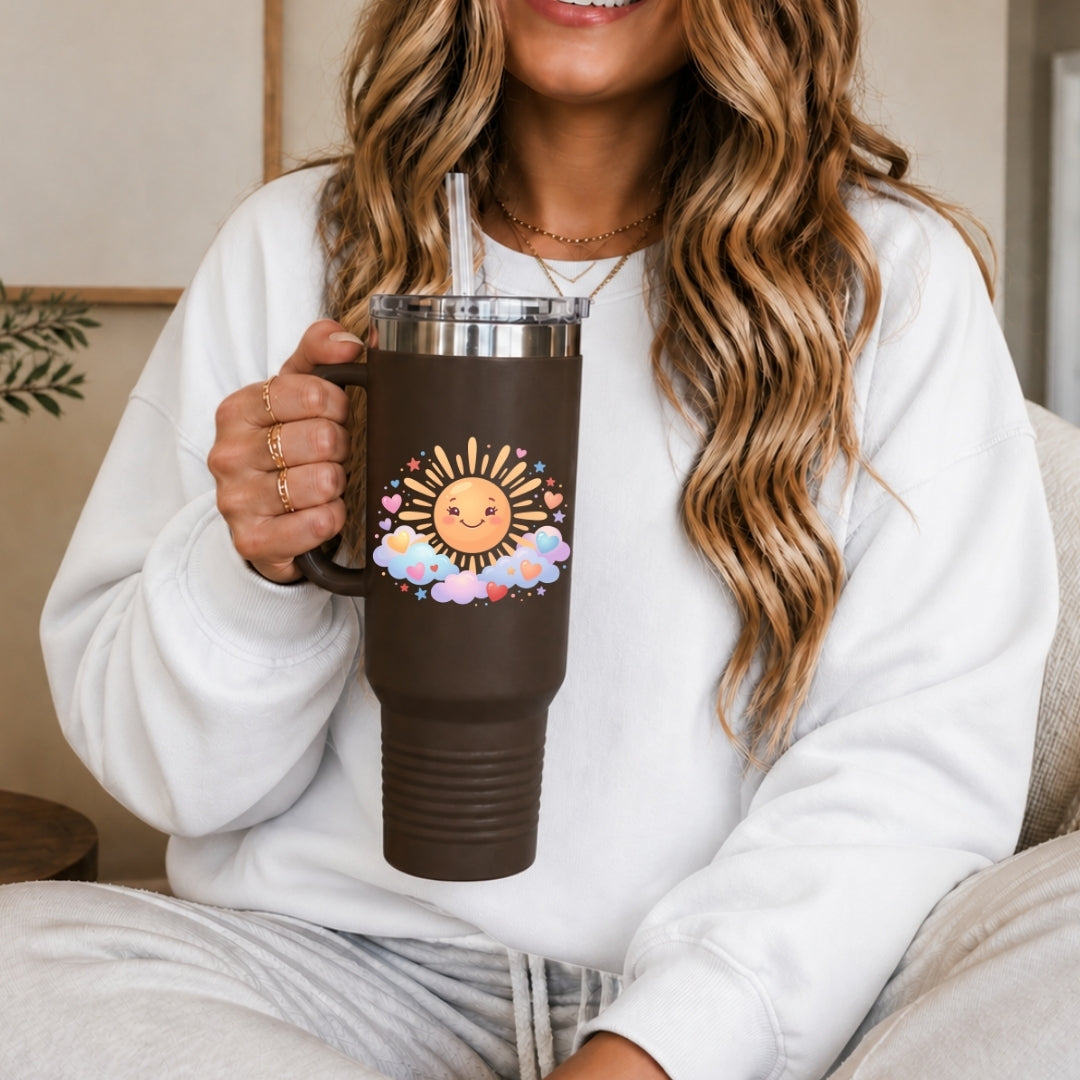 Person holding a brown insulated mug with a colorful design, wearing a white sweatshirt.