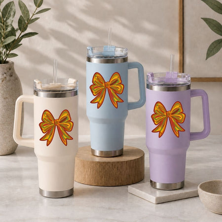 Three insulated mugs with bow designs on a neutral background