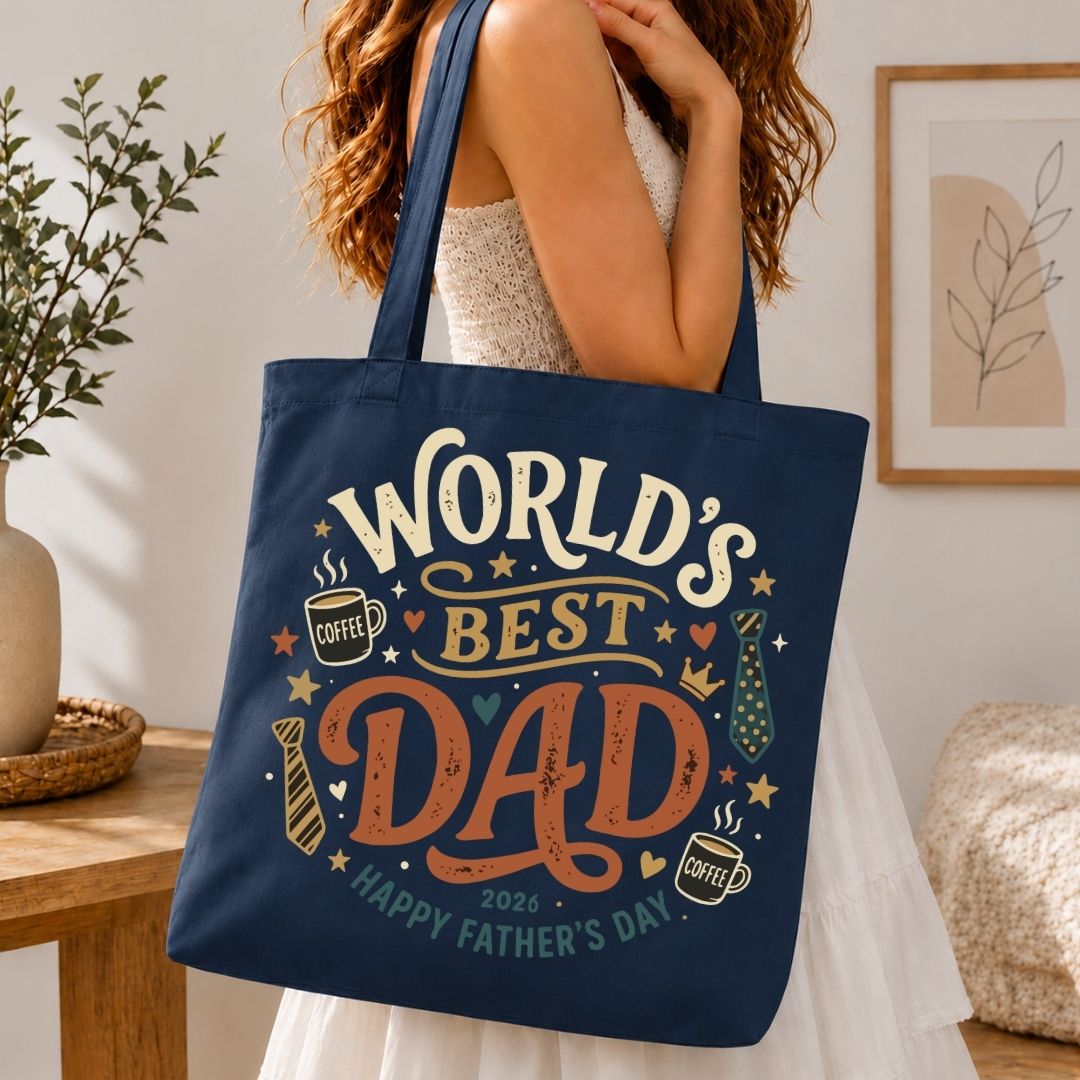 Person holding a navy tote bag with 'World's Best Dad' text in a home setting