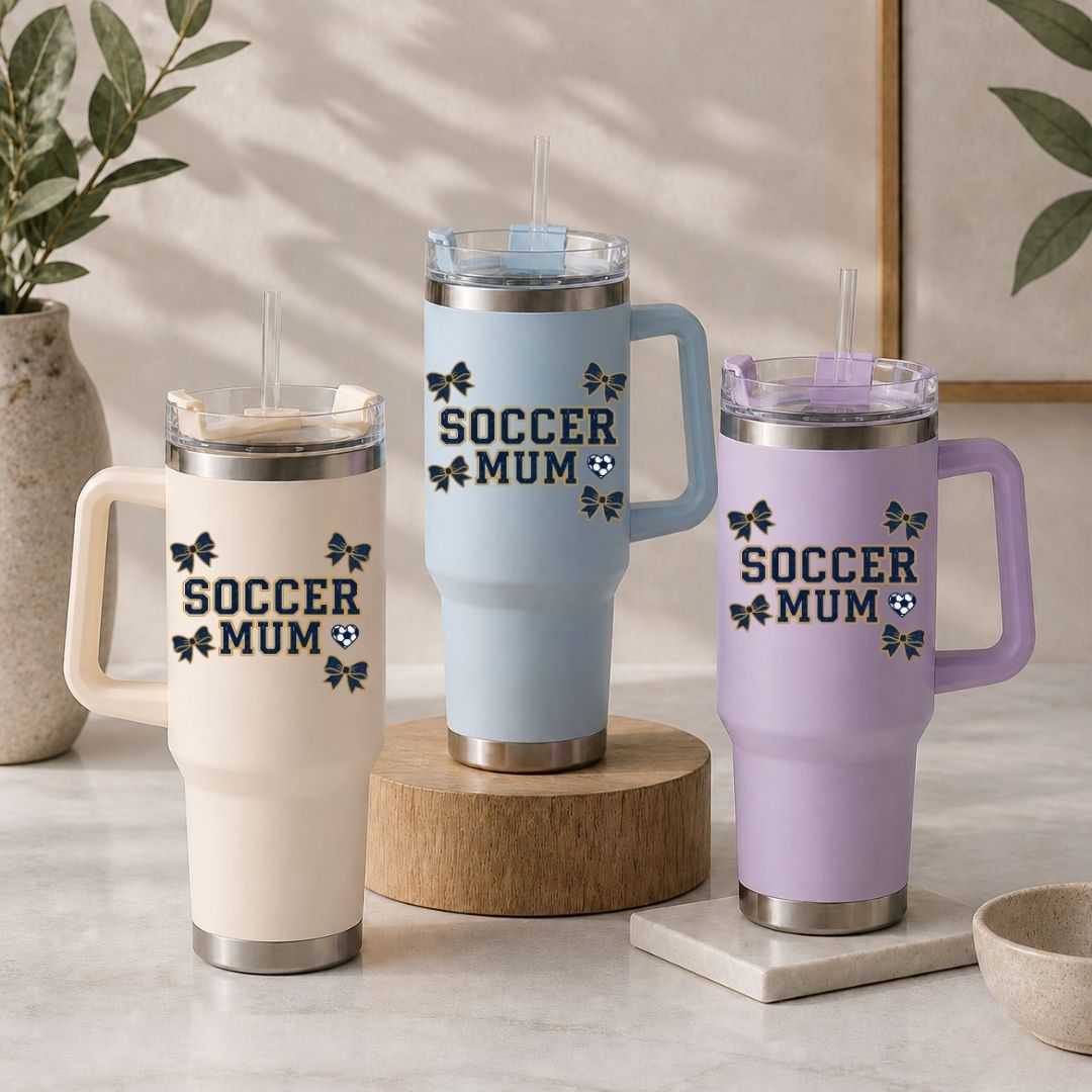 Three insulated travel mugs with 'Soccer Mum' text on a neutral background