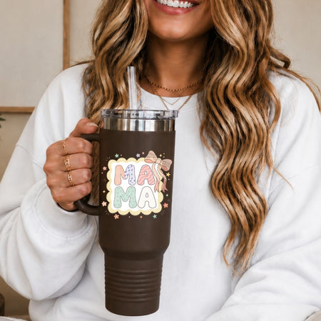 Person holding a brown mug with 'MAMA' design, smiling.