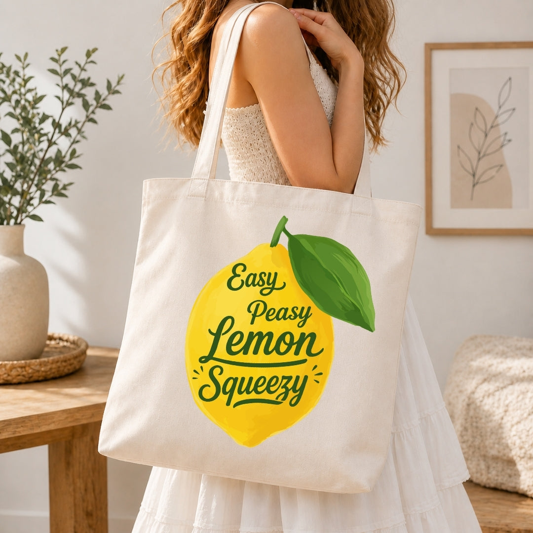 Person holding a tote bag with a lemon graphic and text in a home setting