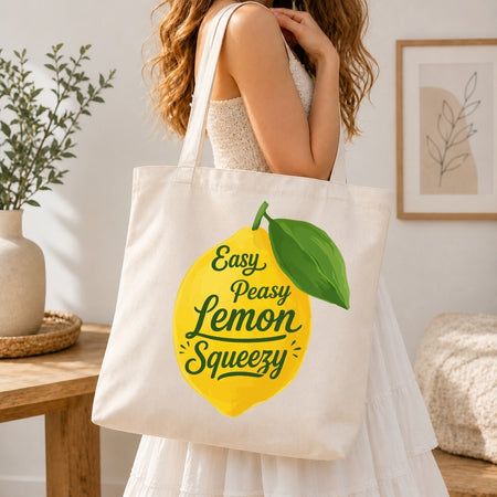 Person holding a tote bag with a lemon graphic and text in a home setting