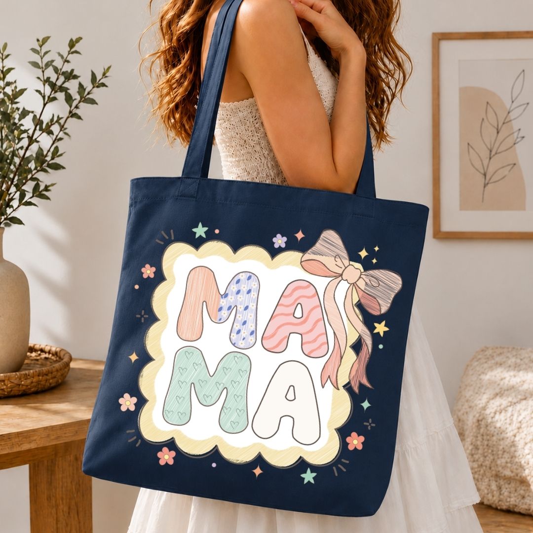 Navy tote bag with 'MAMA' design held by a person in a home setting