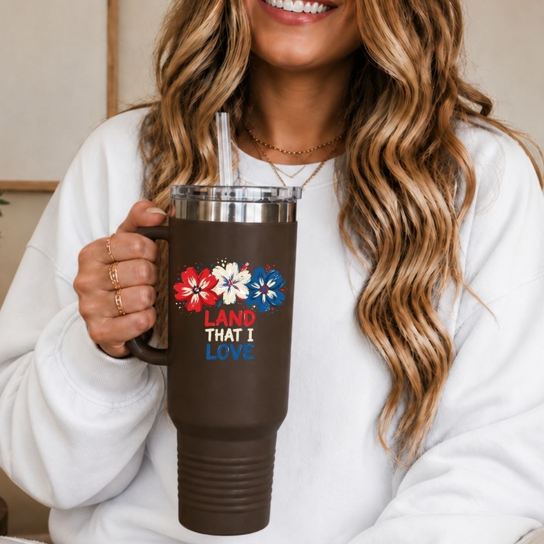 Person holding a brown mug with floral designs and text