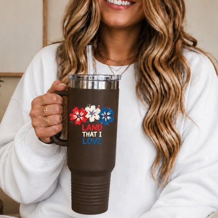 Person holding a brown mug with floral designs and text