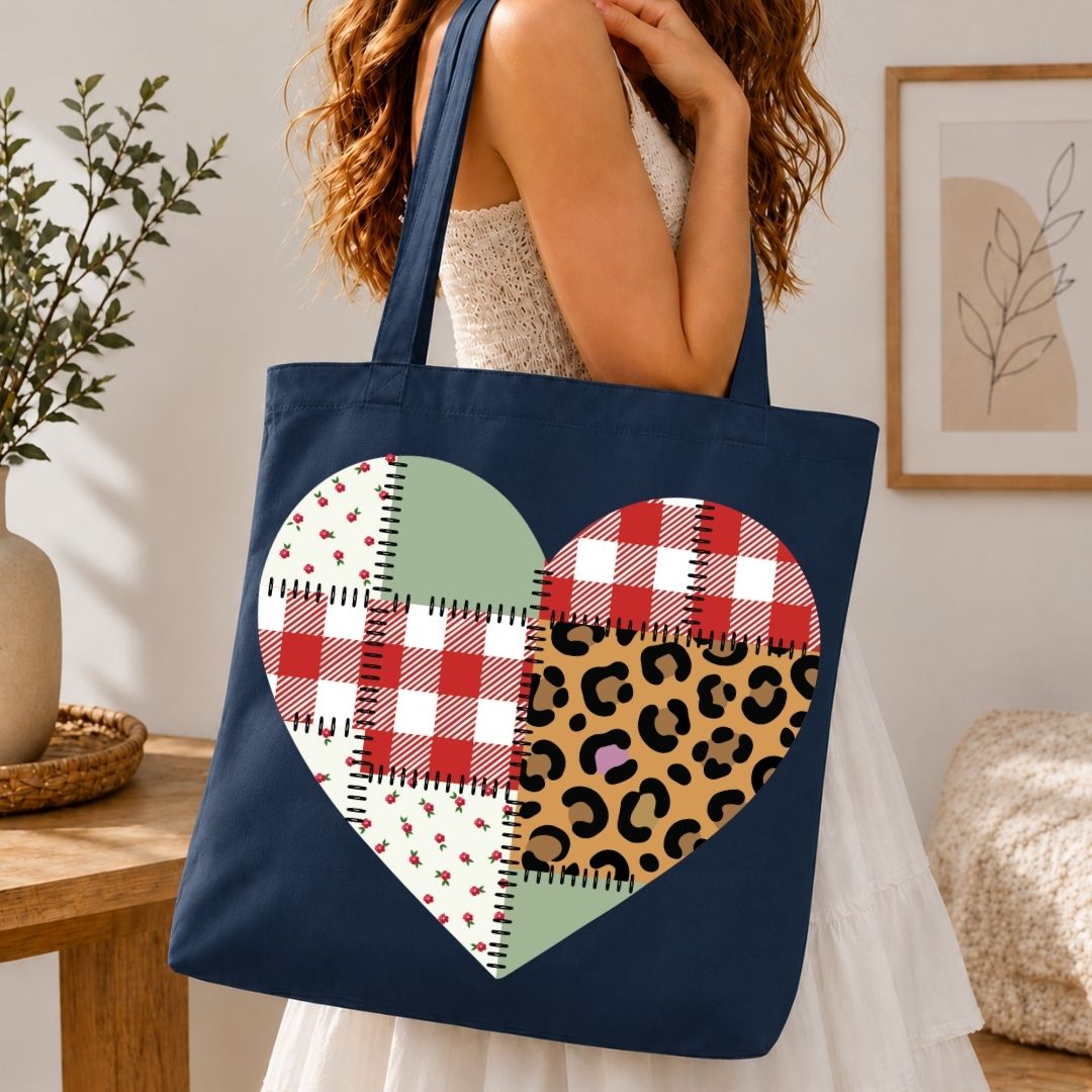 Navy tote bag with colorful heart design held by a person in a home setting.