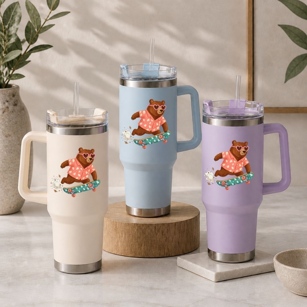 Three insulated travel mugs with bear designs on a neutral background
