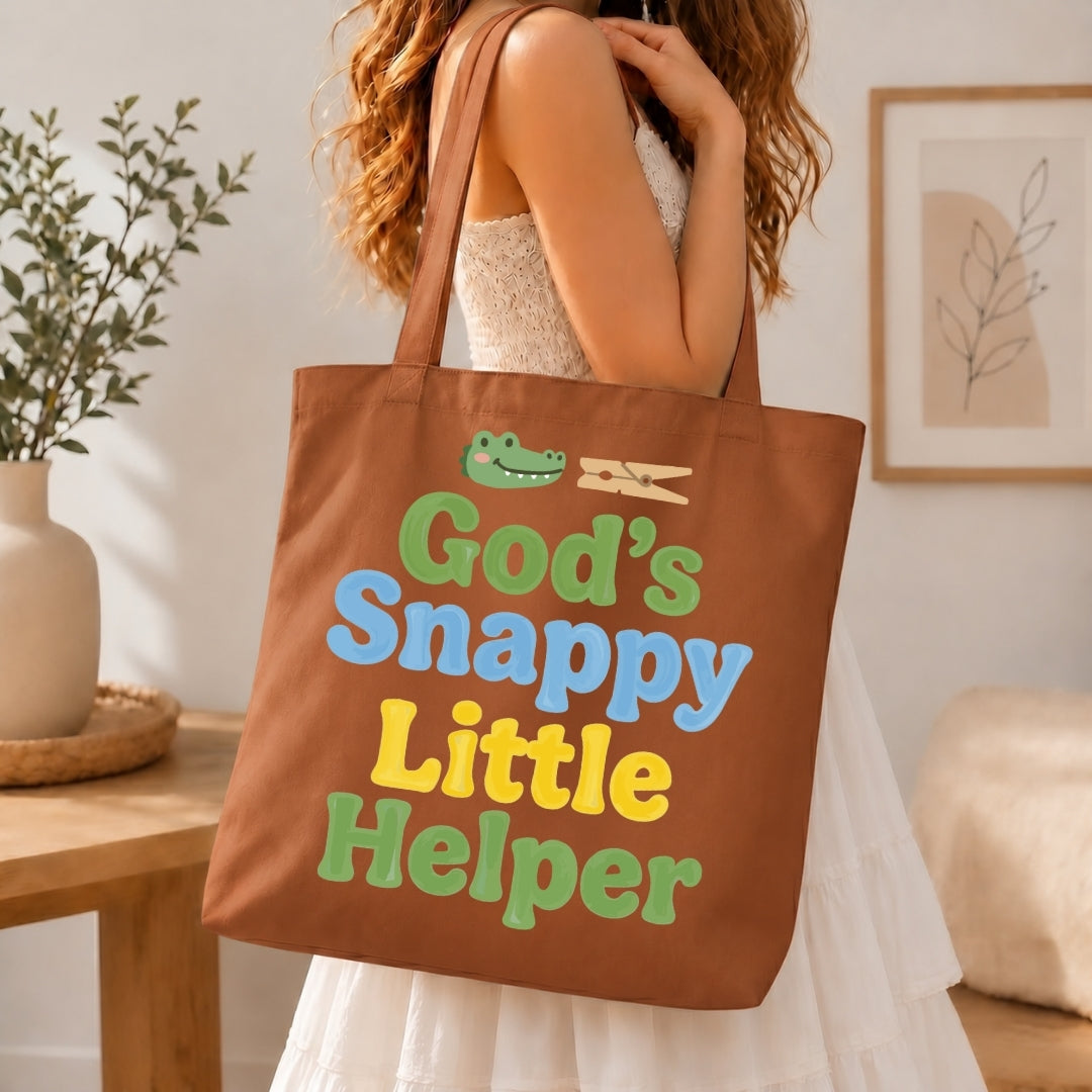 Person holding a brown tote bag with colorful text and graphics in a home setting.