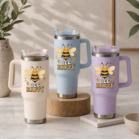 Three insulated travel mugs with bee designs and 'BEE HAPPY' text on a neutral background.