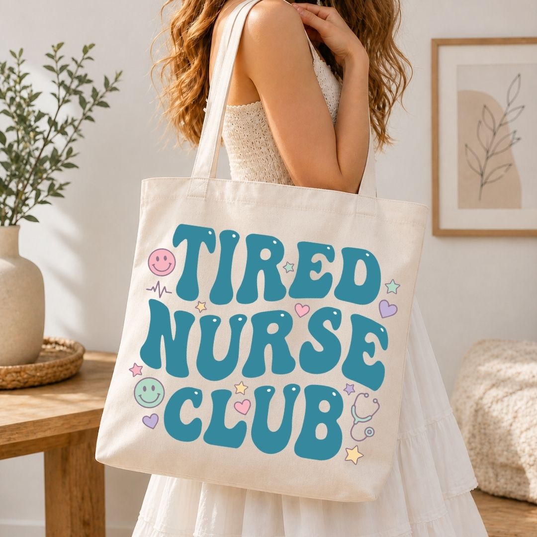 Person holding a tote bag with 'TIRED NURSE CLUB' text in a home setting