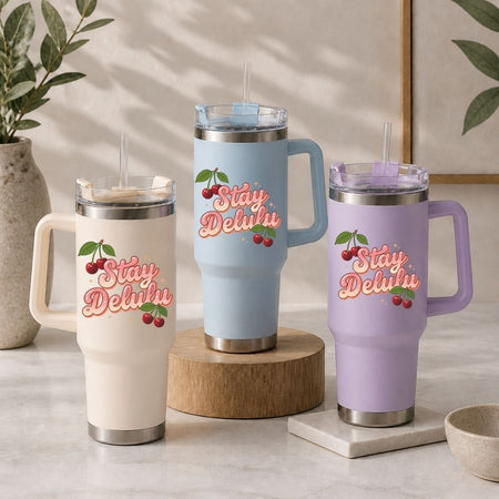 Three insulated travel mugs with 'Stay Delish' text and cherry graphics on a neutral background.