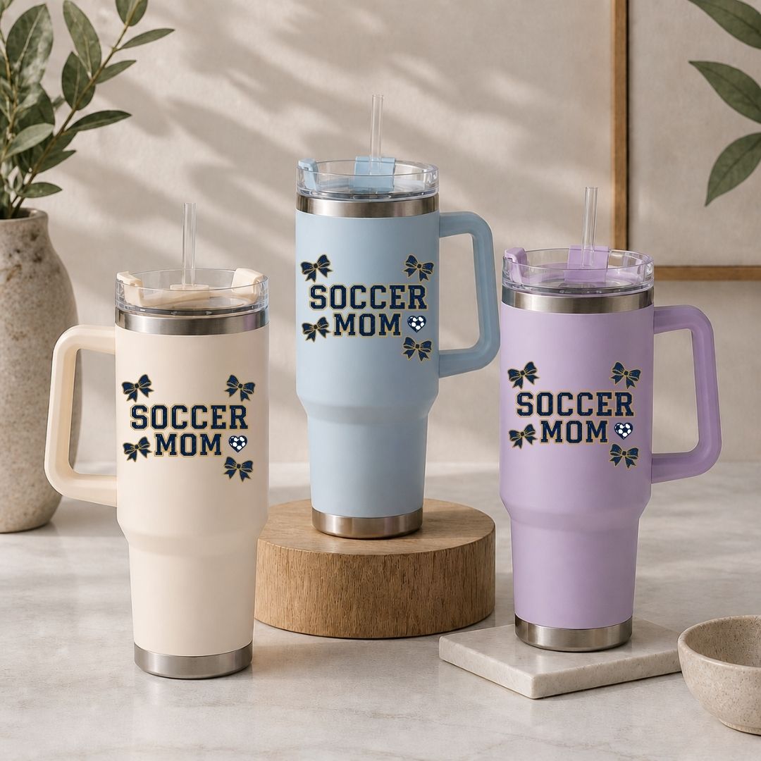 Three insulated travel mugs with 'Soccer Mom' text on a neutral background