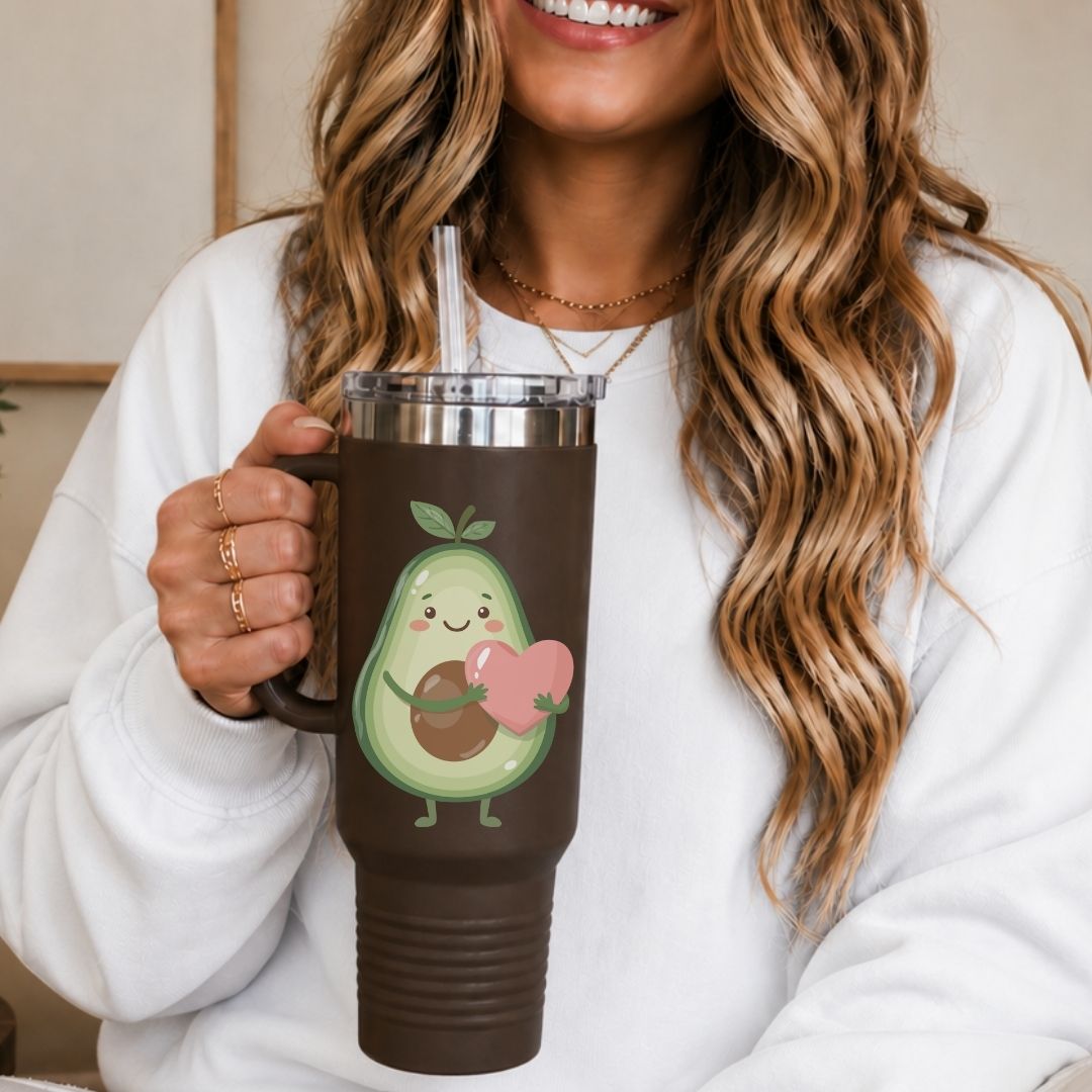 Person holding a brown mug with an avocado design, smiling.