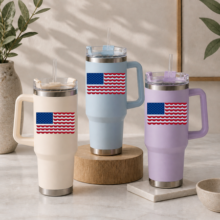 Three insulated travel mugs with American flag designs on a neutral background