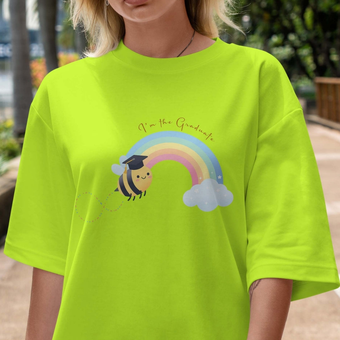 Person wearing a bright green t-shirt with a cartoon bee and rainbow design.