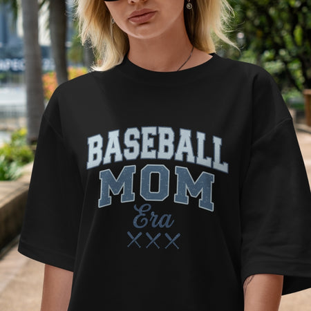 Person wearing a black t-shirt with 'BASEBALL MOM Era XXX' text.