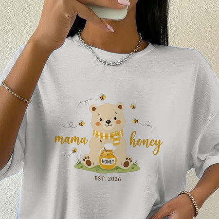 Person wearing a white t-shirt with a bear graphic and 'mama honey' text.