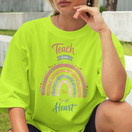 Person wearing a bright green t-shirt with a rainbow design and text.