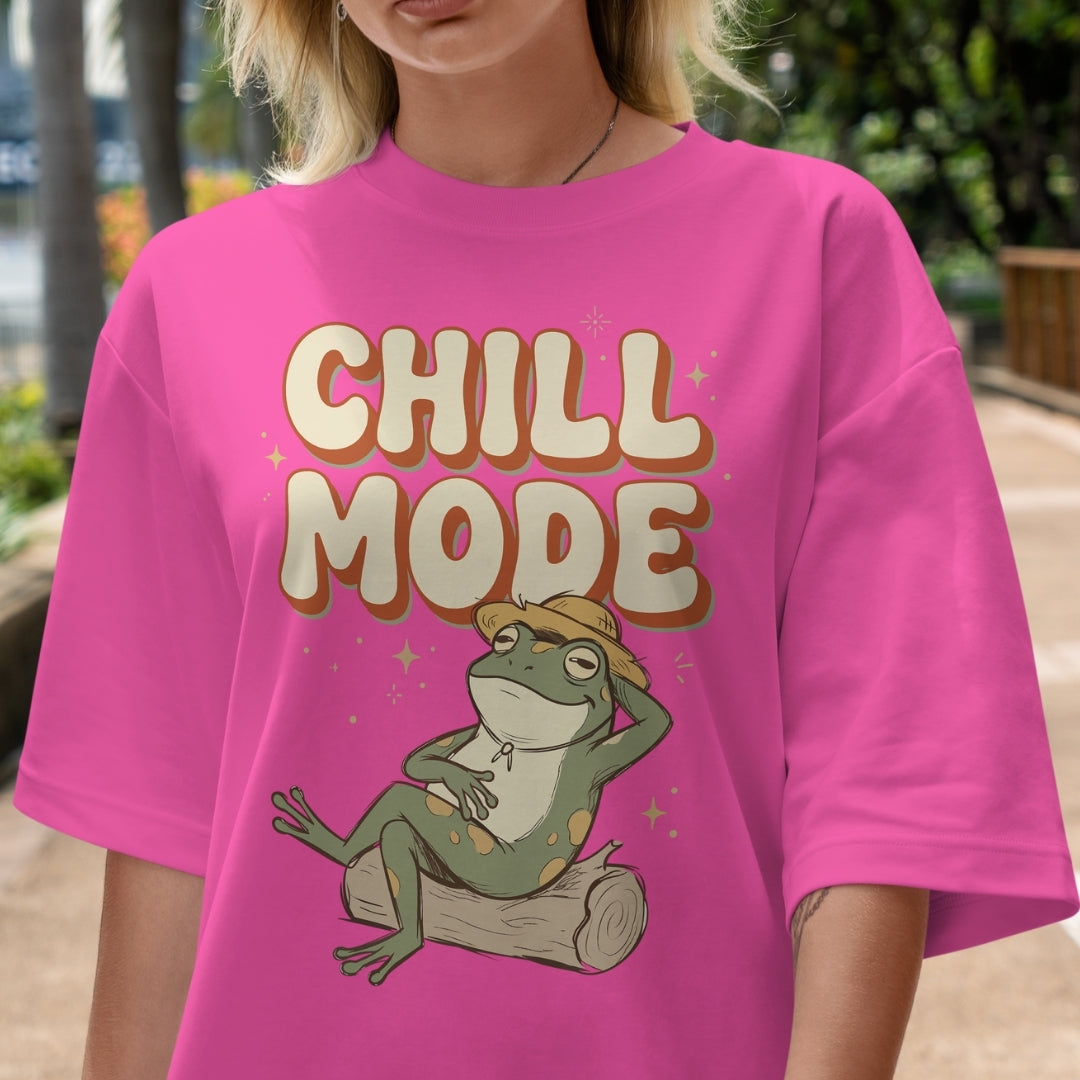 Person wearing a pink t-shirt with a frog graphic and 'Chill Mode' text.