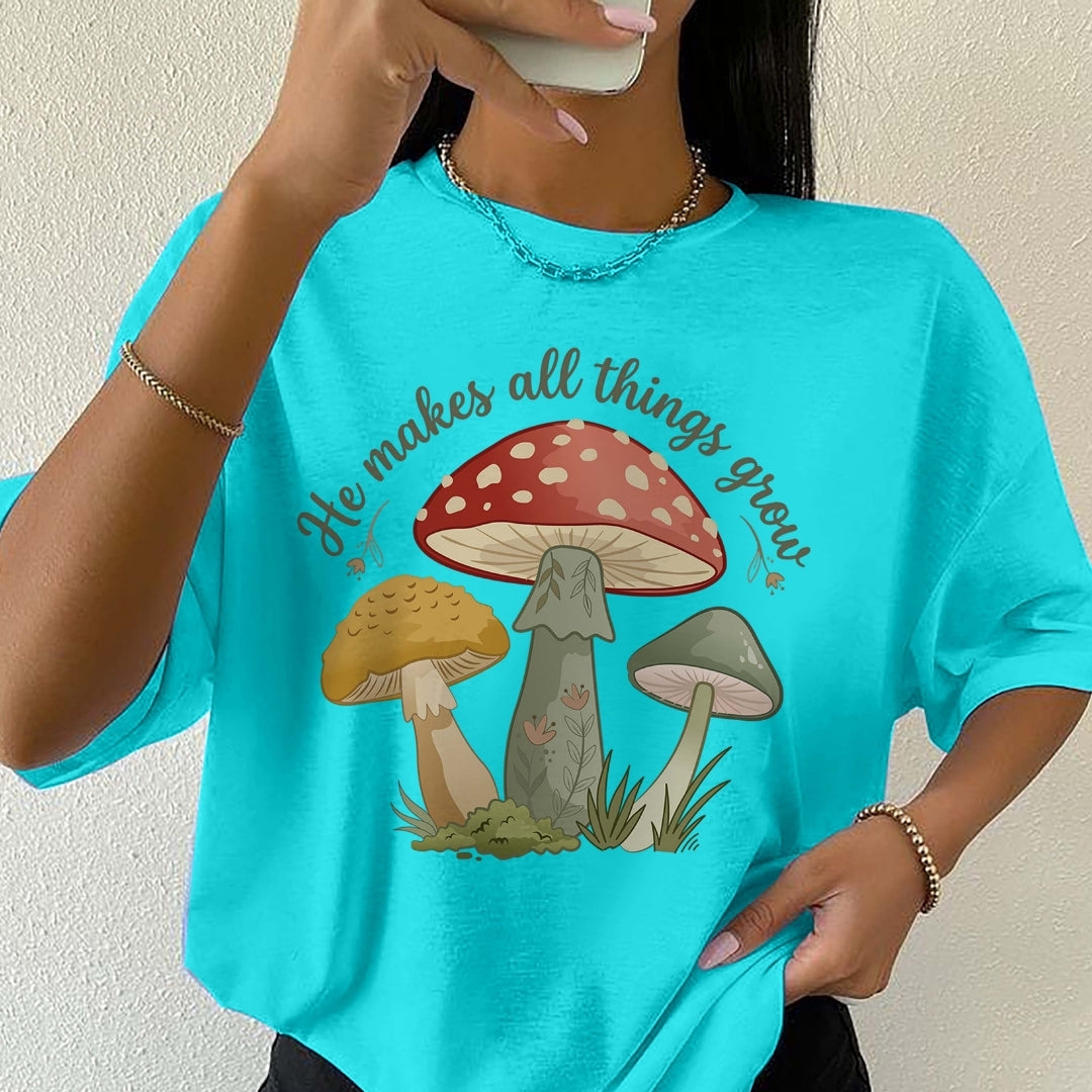 Person wearing a turquoise t-shirt with mushroom graphic and text