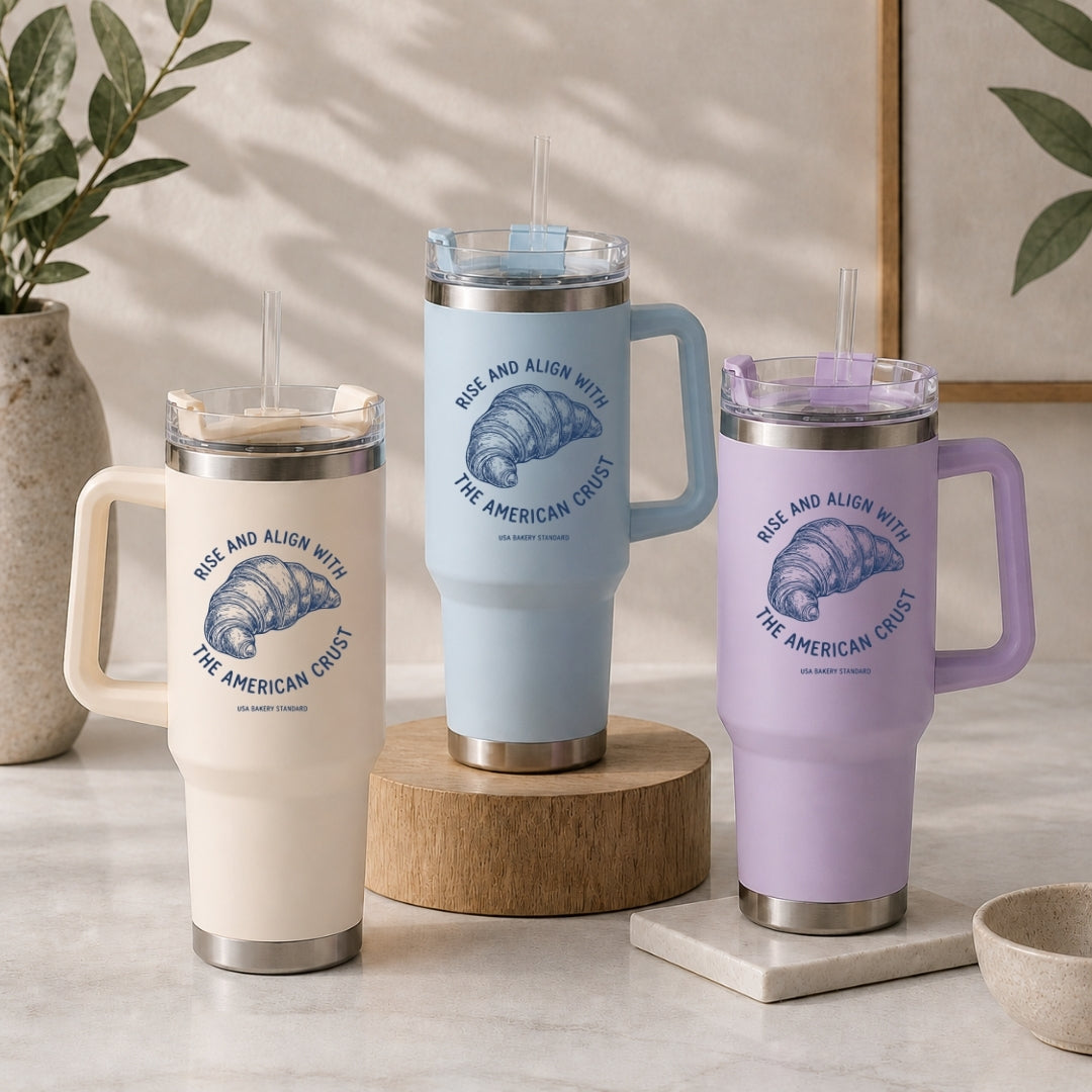 Three insulated travel mugs with handles on a neutral background