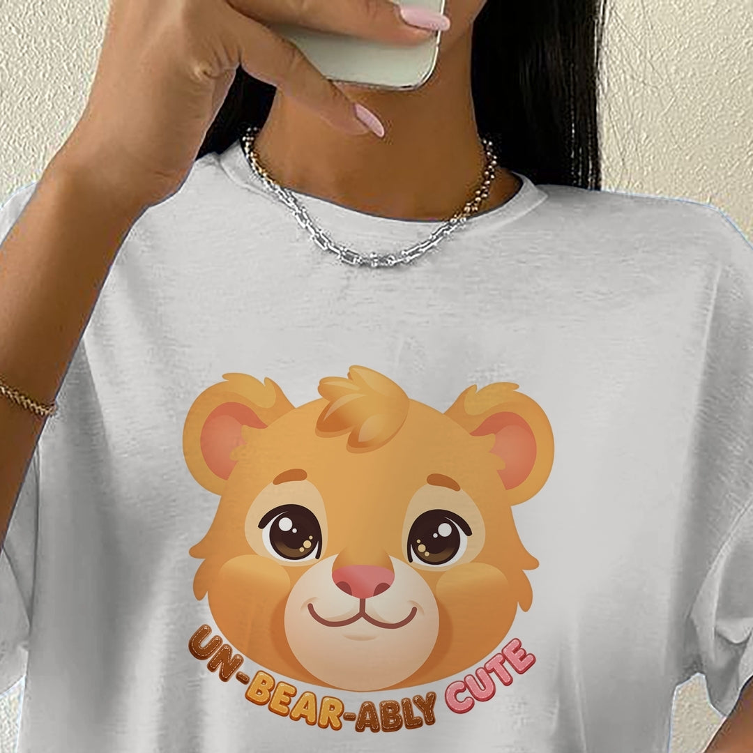 Person wearing a white t-shirt with a cartoon lion design and text.
