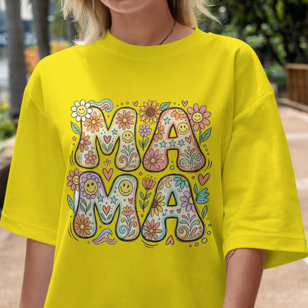 Person wearing a bright yellow t-shirt with 'MAMA' design outdoors.