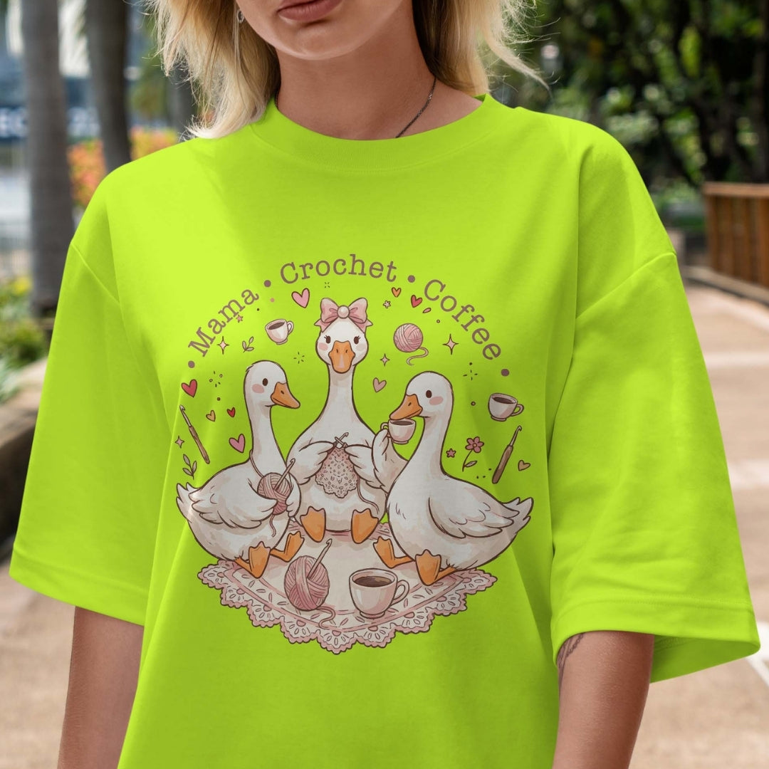 Person wearing a bright green t-shirt with a graphic design of ducks, coffee cups, and text.