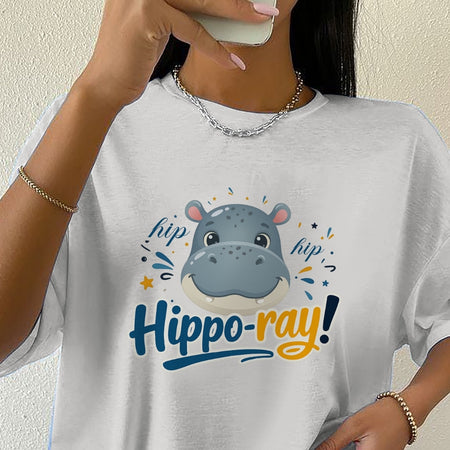 Person wearing a white t-shirt with a hippo graphic and 'hippoo-ray!' text.