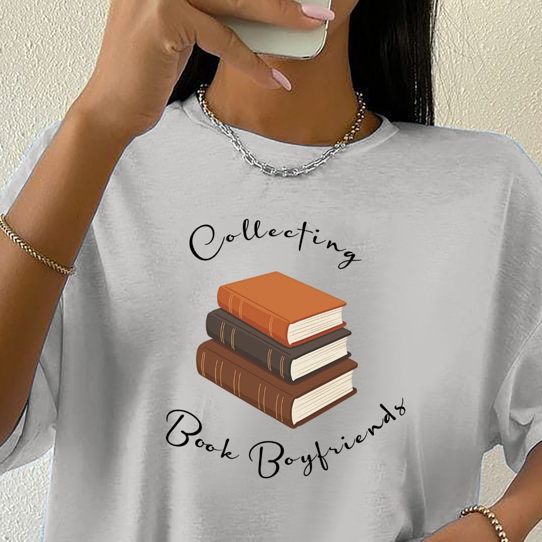 Gray t-shirt with book-themed design and text, worn by a person.