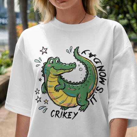 Person wearing a white t-shirt with a cartoon alligator design and text.