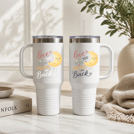 Two white tumblers with a design and text on a neutral background