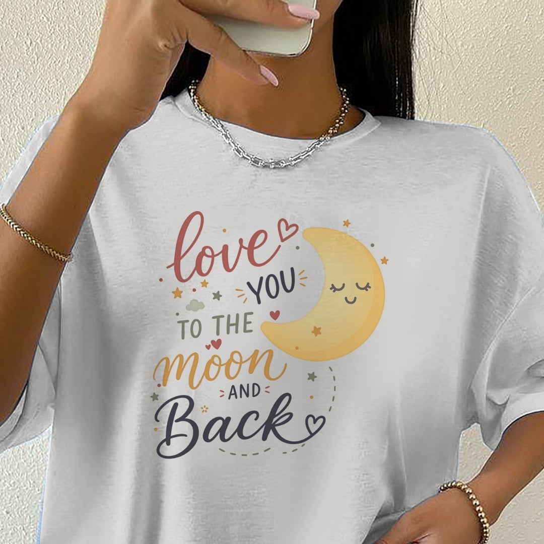 Person wearing a white t-shirt with a moon and text design.