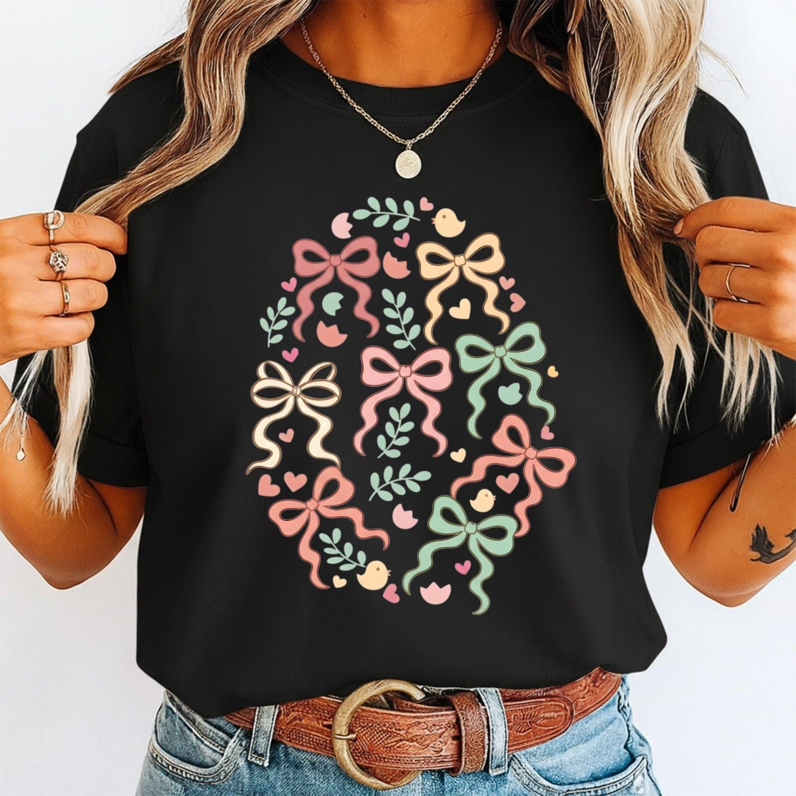 Person wearing a black t-shirt with colorful bow design