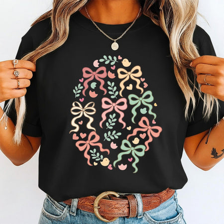 Person wearing a black t-shirt with colorful bow design