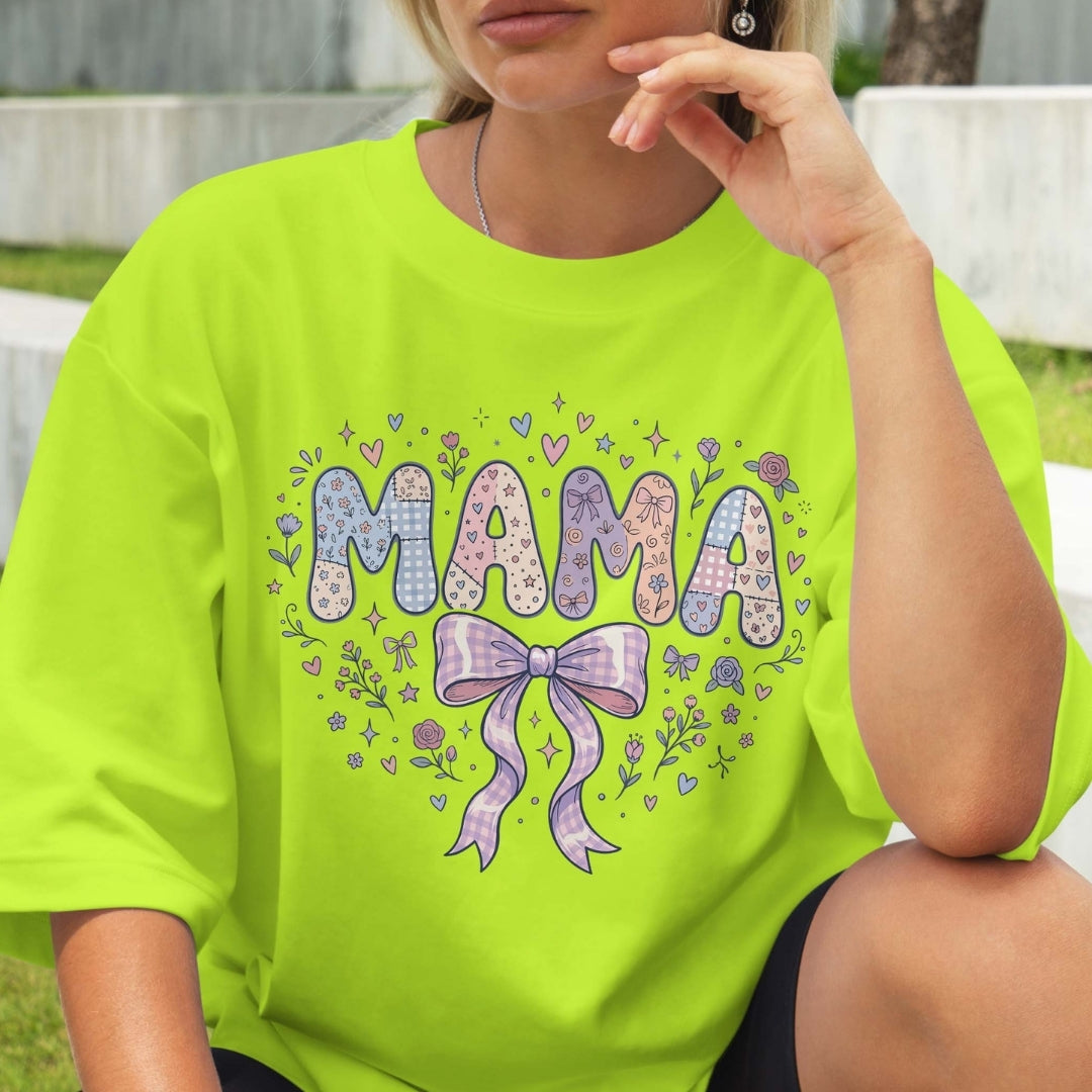 Person wearing a bright green t-shirt with 'MAMA' text and decorative elements.