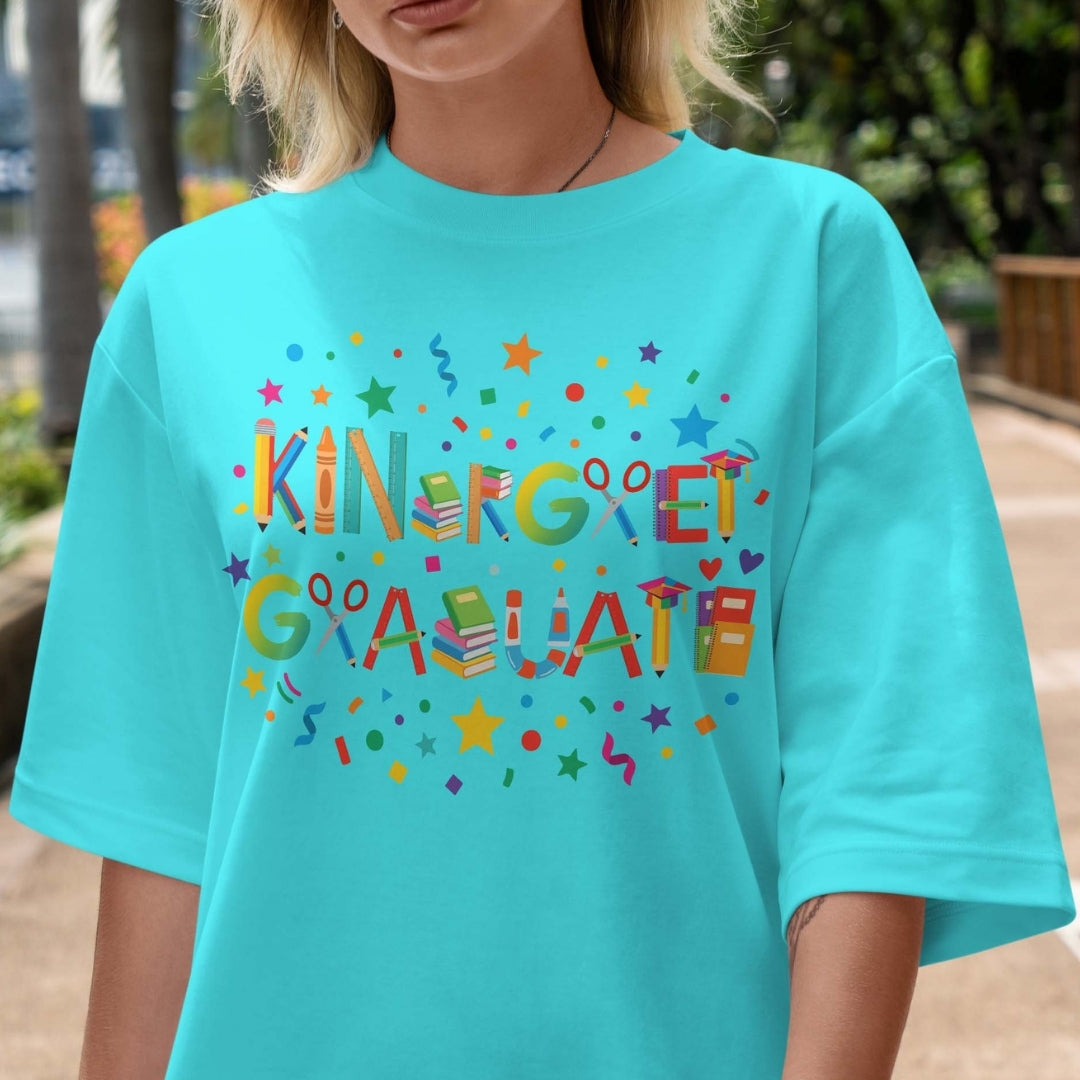 Person wearing a turquoise t-shirt with colorful 'Kindergarten Graduate' text.