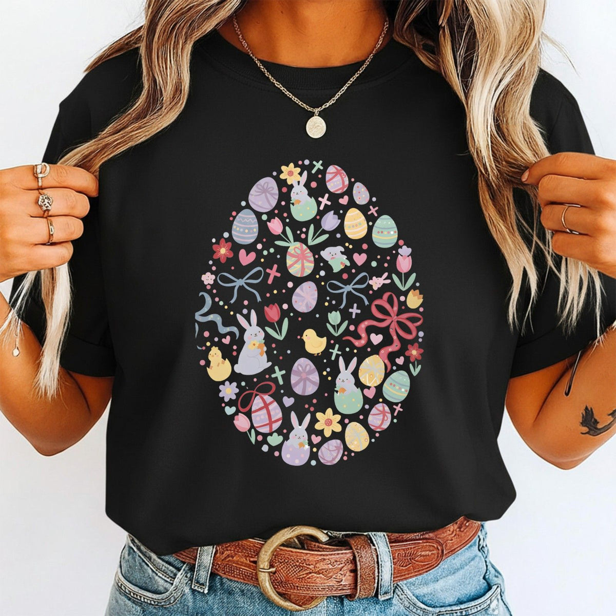 Person wearing a black t-shirt with a colorful Easter egg design.