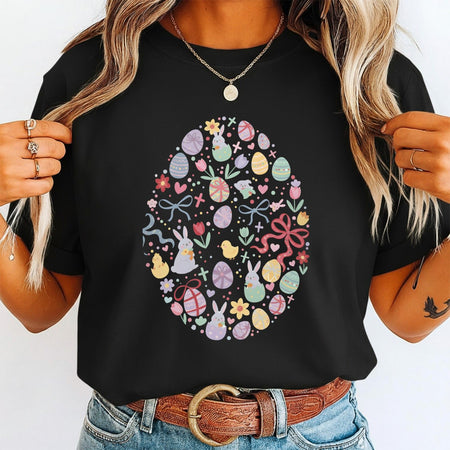 Person wearing a black t-shirt with a colorful Easter egg design.