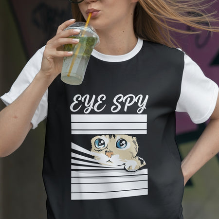 Person wearing a black t-shirt with a cat graphic and 'Eye Spy' text, holding a drink.