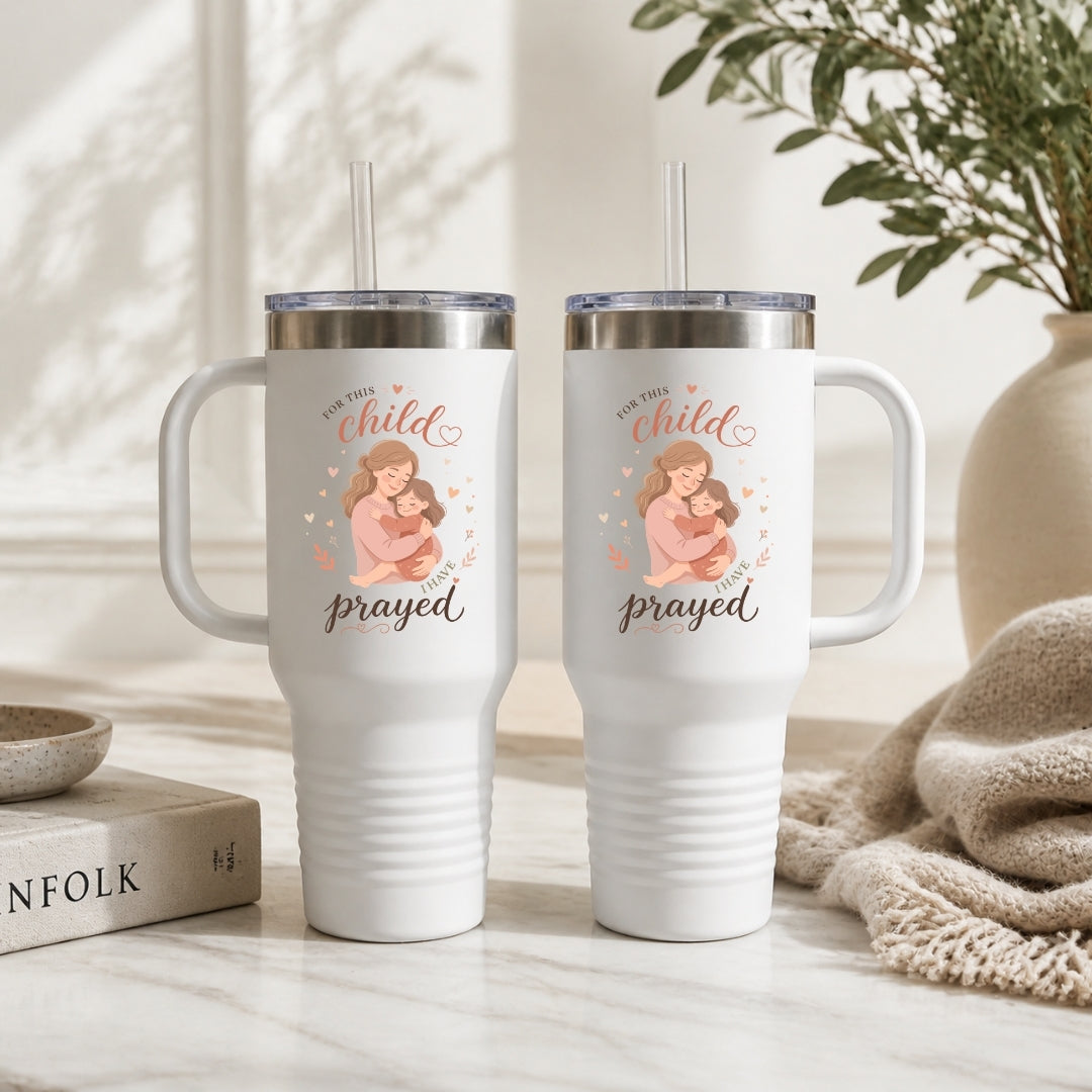 Two white tumblers with a design and text on a neutral background