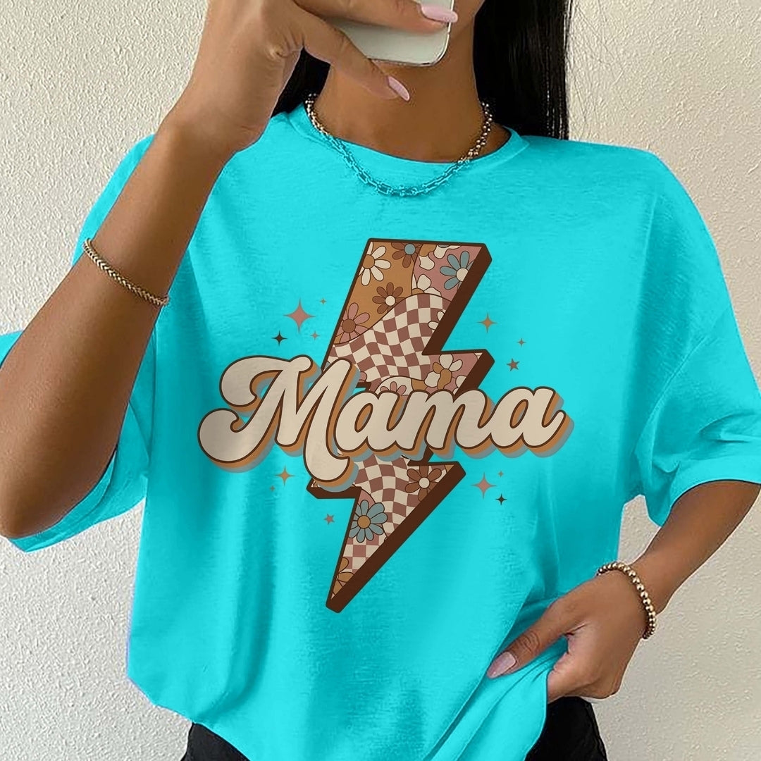 Person wearing a turquoise t-shirt with a graphic design and the word 'Mama'.